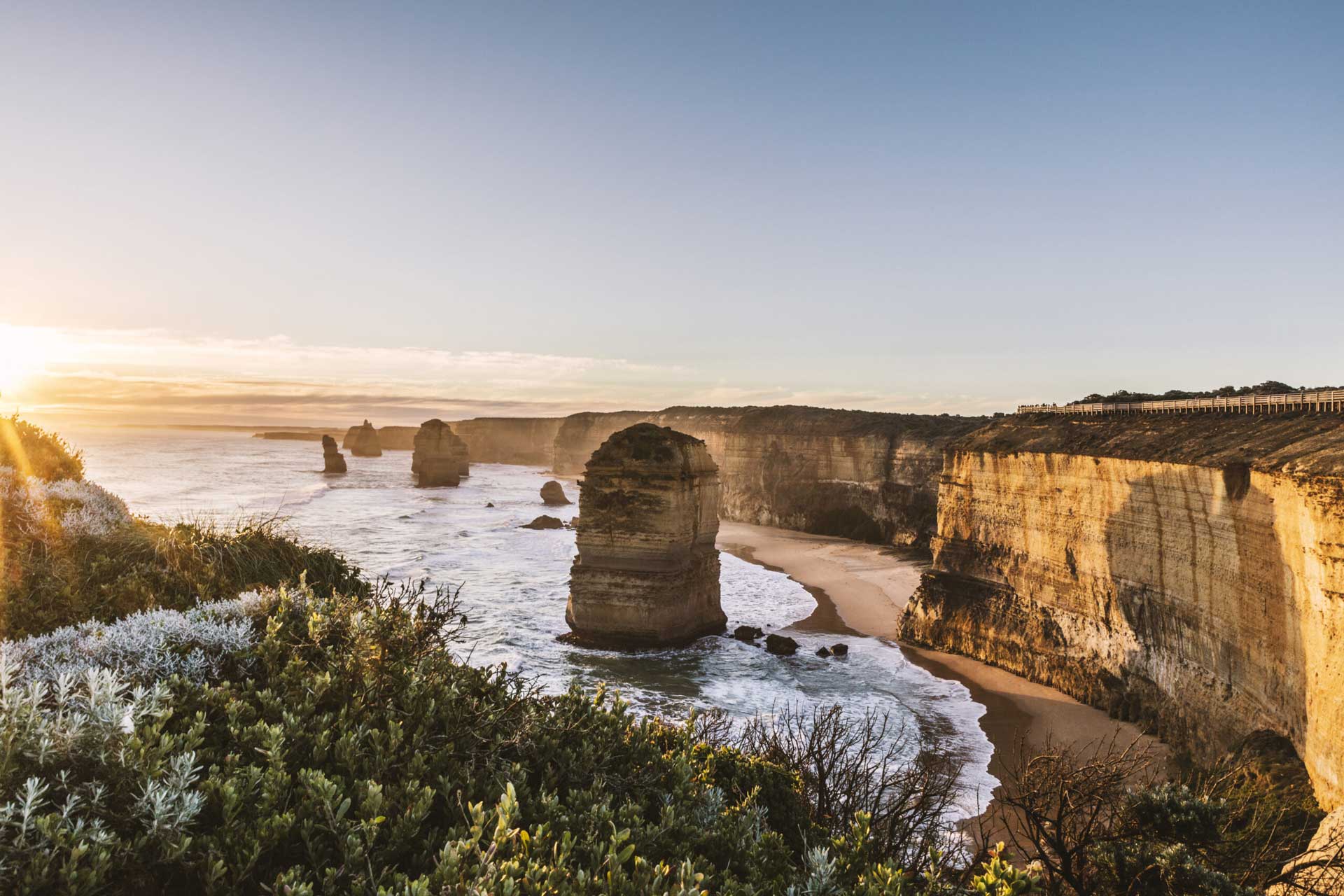 A breathtaking view of the Twelve Apostles rock formations along the Great Ocean Road at sunset.
