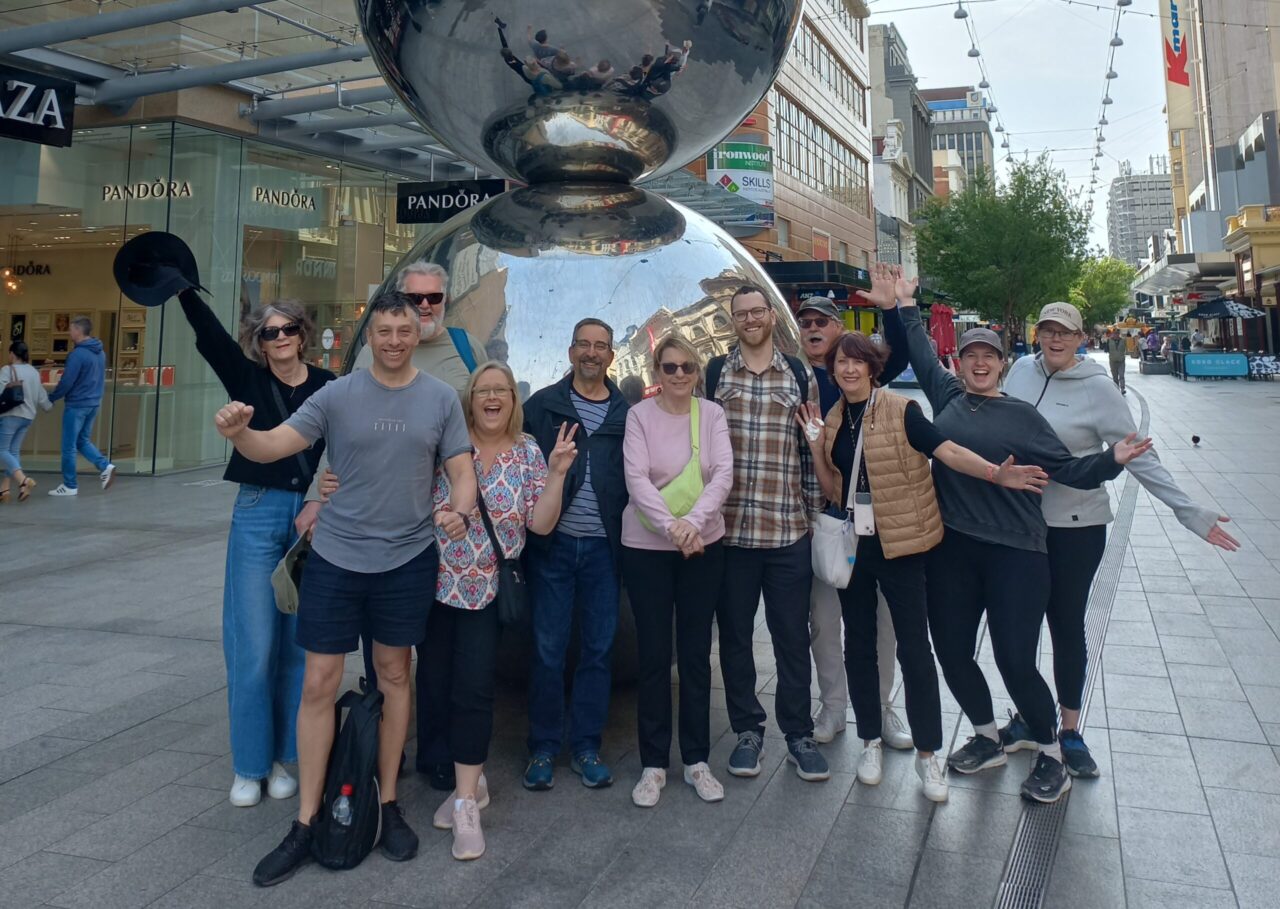 A Flamboyance tours group photo at the Ball statue at Rundle Mall on the Welcome to Adelaide Tour.